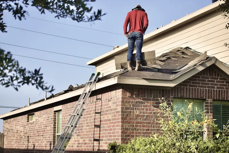 Professional roofer working on a residential roof in Oakwood Manor